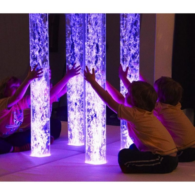 Child engaging with the Experia Superactive LED Bubble Tube in a sensory room, demonstrating interactive colour-controlled bubble tube play for motor planning and colour recognition