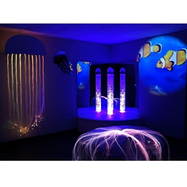 Experia Calming Underwater Adventure Room landscape view with bubble tube glowing in purple, showing the immersive underwater-themed sensory environment