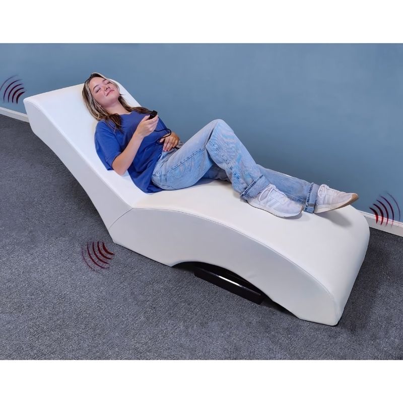 Top view of the Experia Vibroacoustic Lounger with a woman lying on the full-length phthalate-free vinyl surface, showing the 72-inch lounger dimensions from above