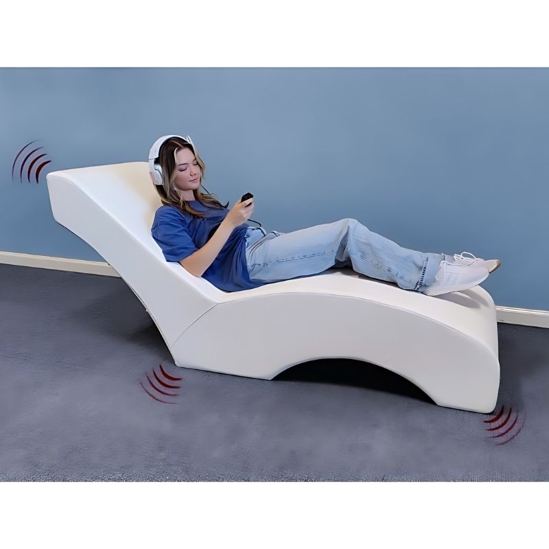 Experia Vibroacoustic Lounger landscape view showing a woman enjoying music through the vibroacoustic lounger, demonstrating full-body music vibration therapy