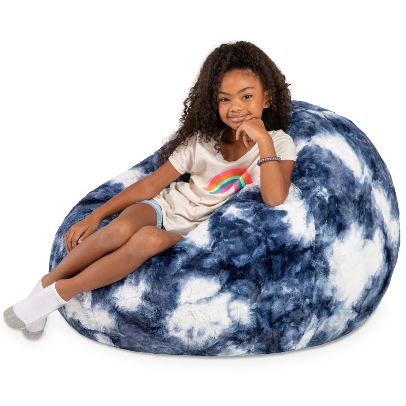 A child reclining into the Jaxx Cocoon Fur faux fur bean bag chair in Blueprint, showing the foam filling mold into a chair shape