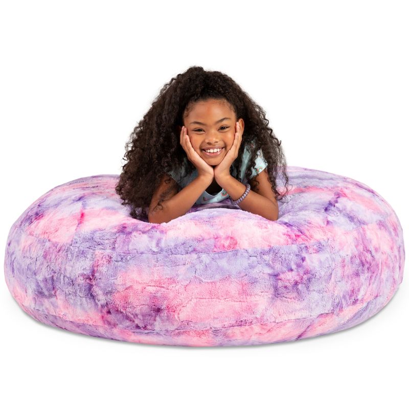 A child resting on the Jaxx Cocoon Fur faux fur bean bag chair in Unicorn, a cozy crash pad texture kids love