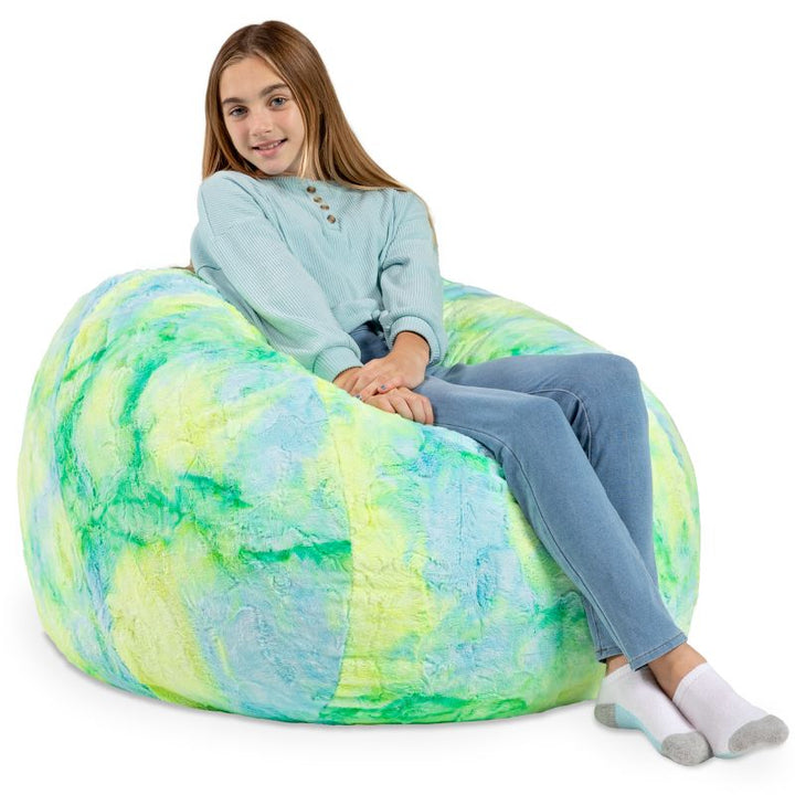 Child seated in the Jaxx Saxx faux fur bean bag chair in Firefly, a bright tactile sensory seat for kids