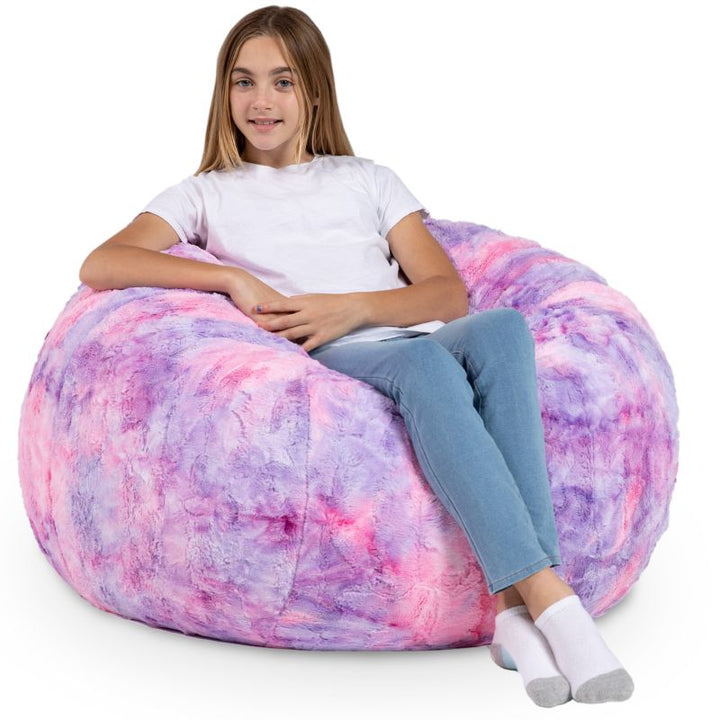 Child seated in the Jaxx Saxx faux fur bean bag chair in Unicorn, a plush tactile sensory seat for kids