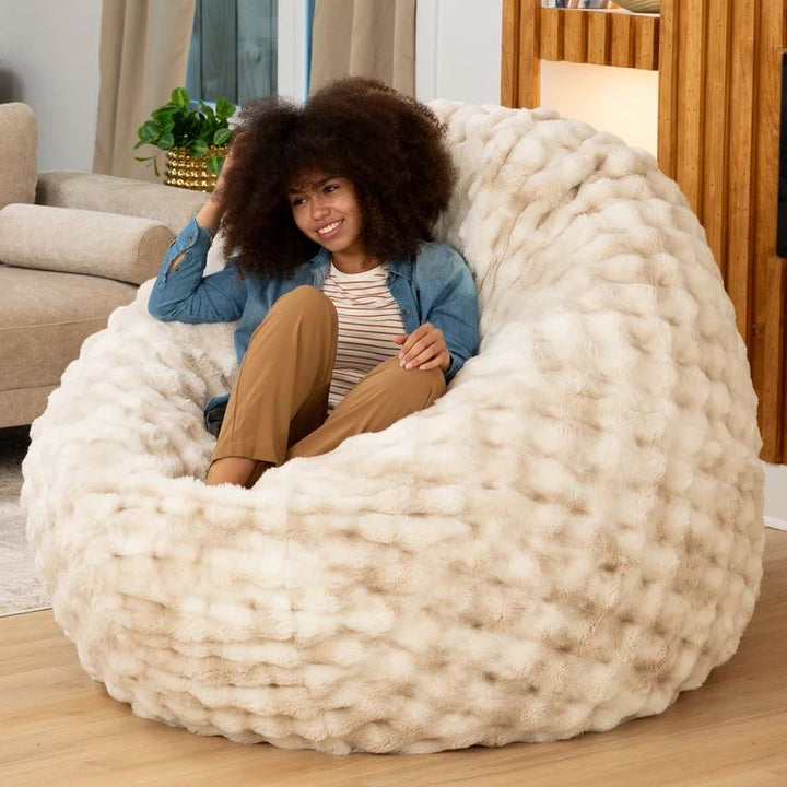 Big Snuggler by Raven-Symone faux fur bean bag lounger in Phantom Cream flipped upright as a deep pressure chair