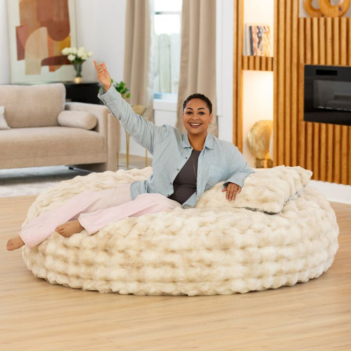 Big Snuggler by Raven-Symone faux fur bean bag lounger in Phantom Cream shown flat with room to stretch out