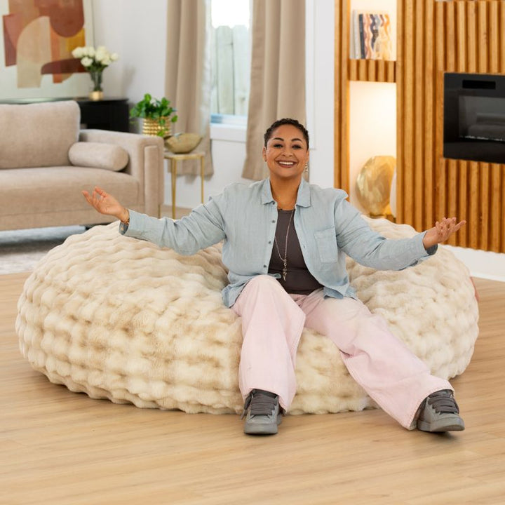 Big Snuggler by Raven-Symone faux fur bean bag lounger in Phantom Cream, a spacious floor lounger for sharing