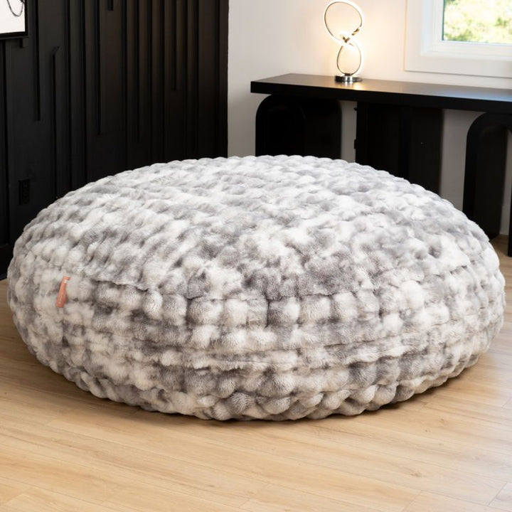 Big Snuggler by Raven-Symone faux fur bean bag lounger in Phantom Gray styled in a modern living room