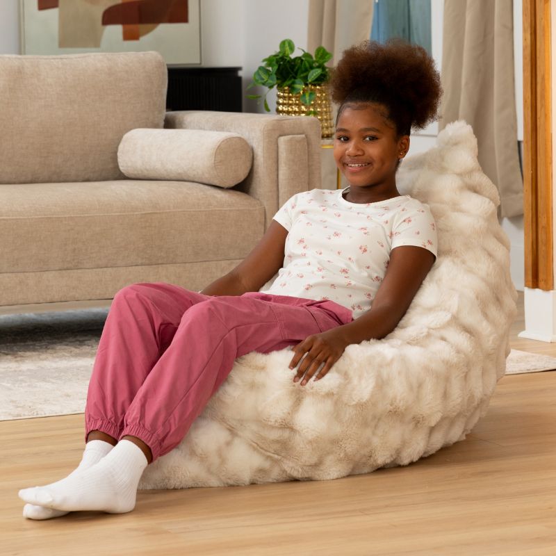 Girl reclining against the CrashPuff by Raven-Symoné floor lounger propped upright in Phantom Cream