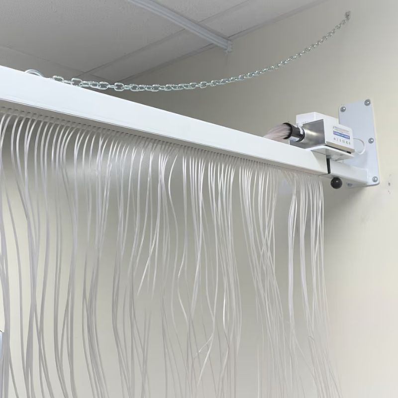 Close-up of the adjustable wall bracket and light source on the TFH Fiber Optic Curtain, showing the 100 cascading tails