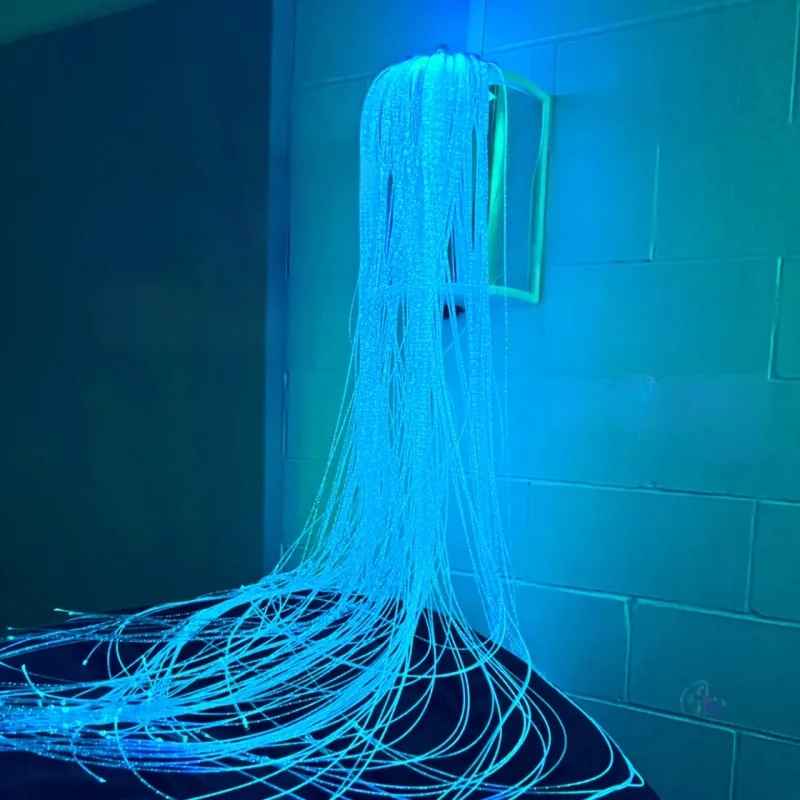 TFH Fibre Optic Wall Sconce mounted high on a wall with fiber optic tails cascading down, creating a multi-sensory room lighting display