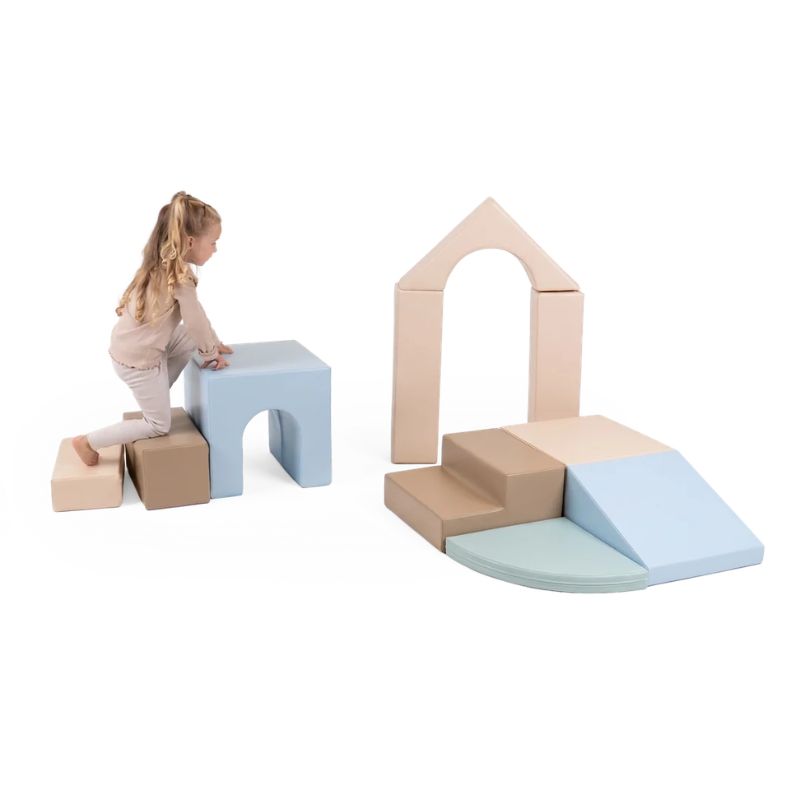 A young girl climbing the step shapes of the IGLU Foam Play Set Creativity, building gross motor skills and balance