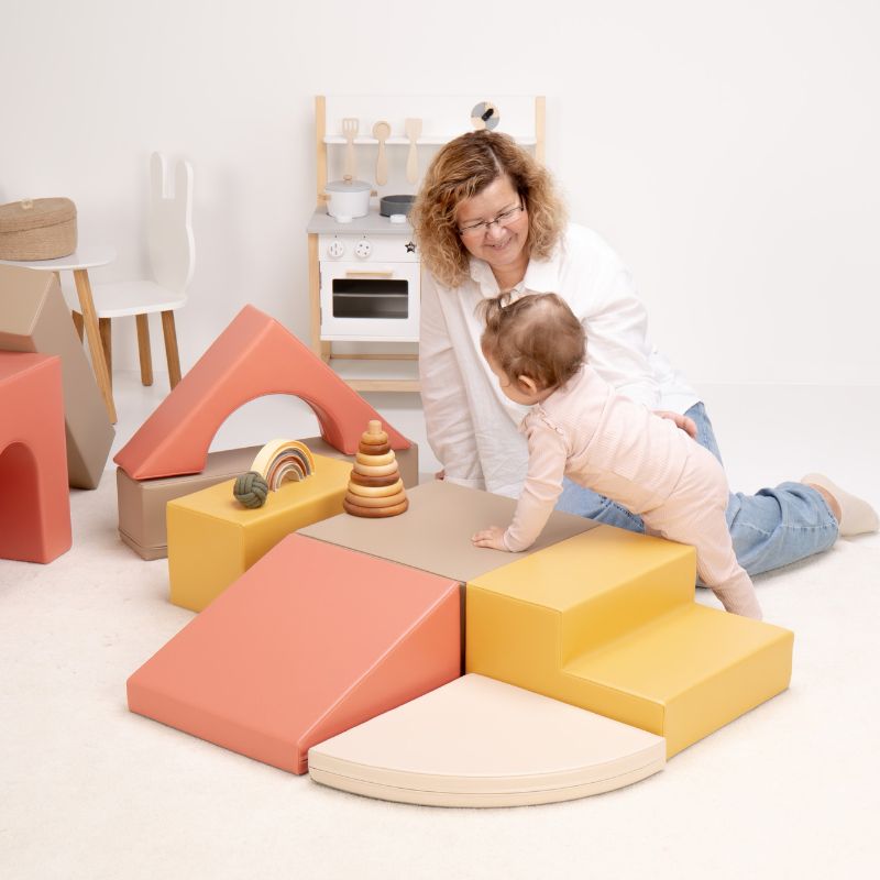 Baby crawling from the steps onto the platform of the IGLU Foam Play Set - Creativity, building strength on foam climbing blocks