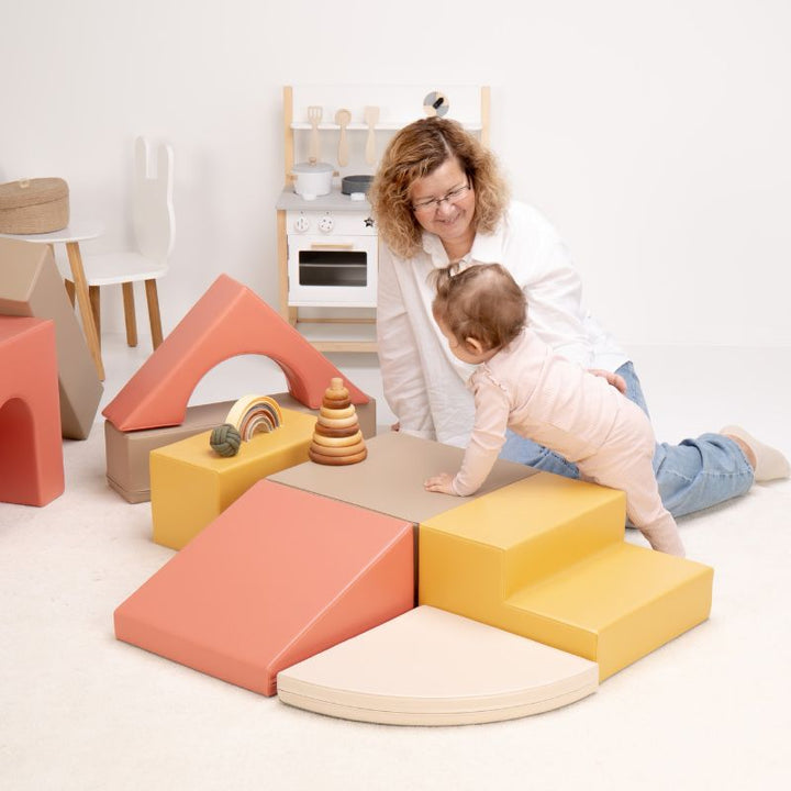 Baby crawling from the steps onto the platform of the IGLU Foam Play Set - Creativity, building strength on foam climbing blocks