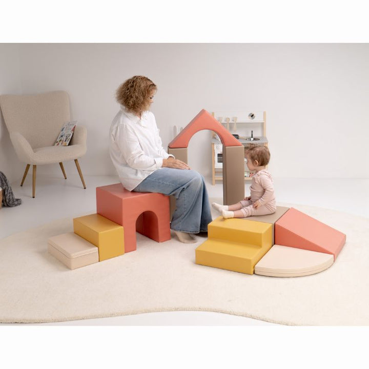 Baby sitting beside the assembled arch of the IGLU Foam Play Set - Creativity during calm baby soft play at home
