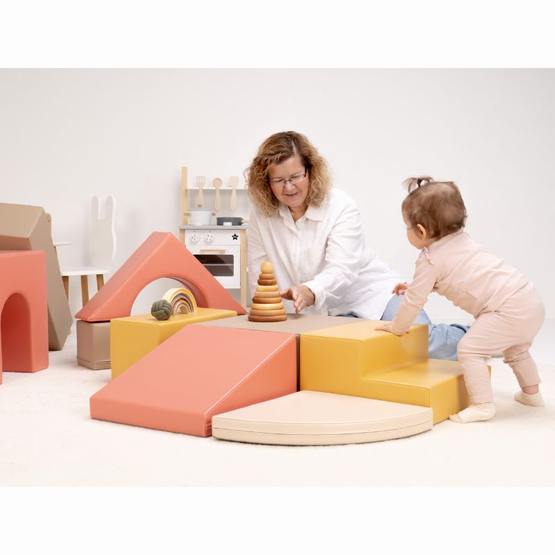 Baby standing at the steps of the IGLU Foam Play Set - Creativity, practicing balance with toddler climbing toys made of soft foam