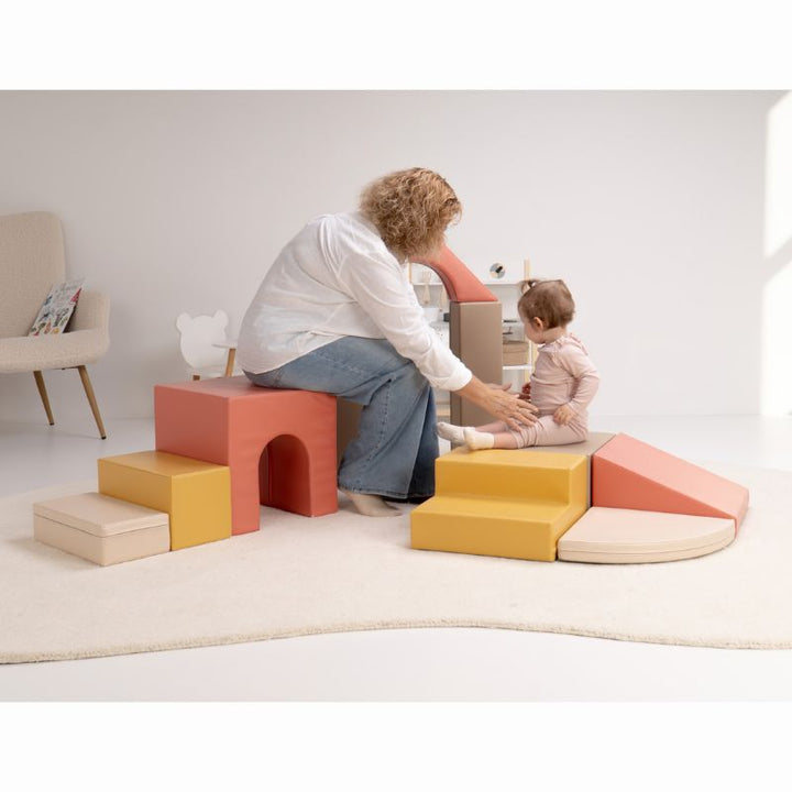 Caregiver and baby sitting together on the IGLU Foam Play Set - Creativity, a modular soft play set with tunnel cube, steps and ramp