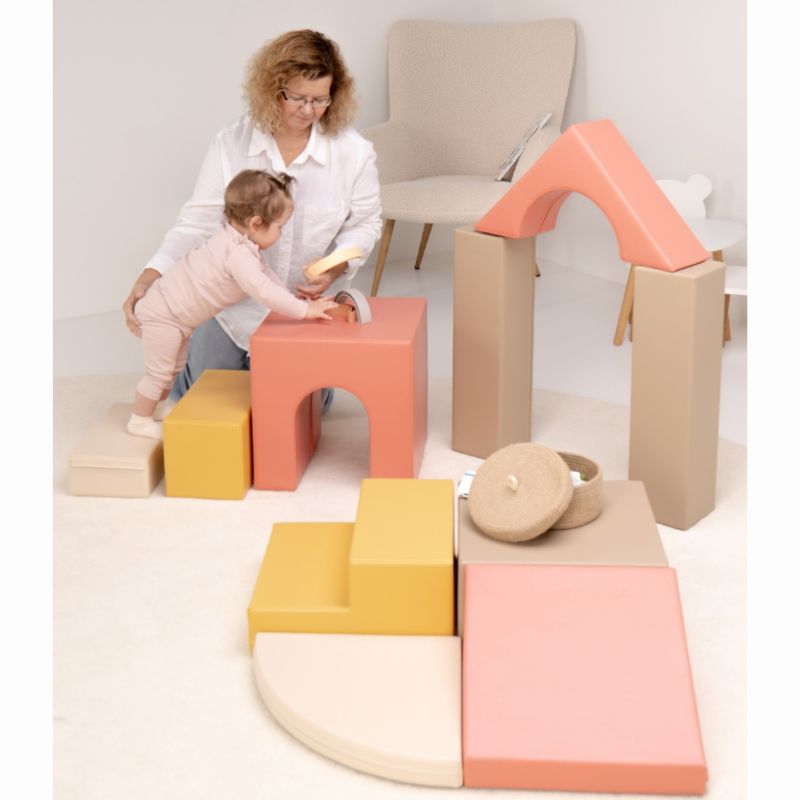 Toddler standing at the tunnel cube with the full IGLU Foam Play Set - Creativity arranged as a modular soft play set