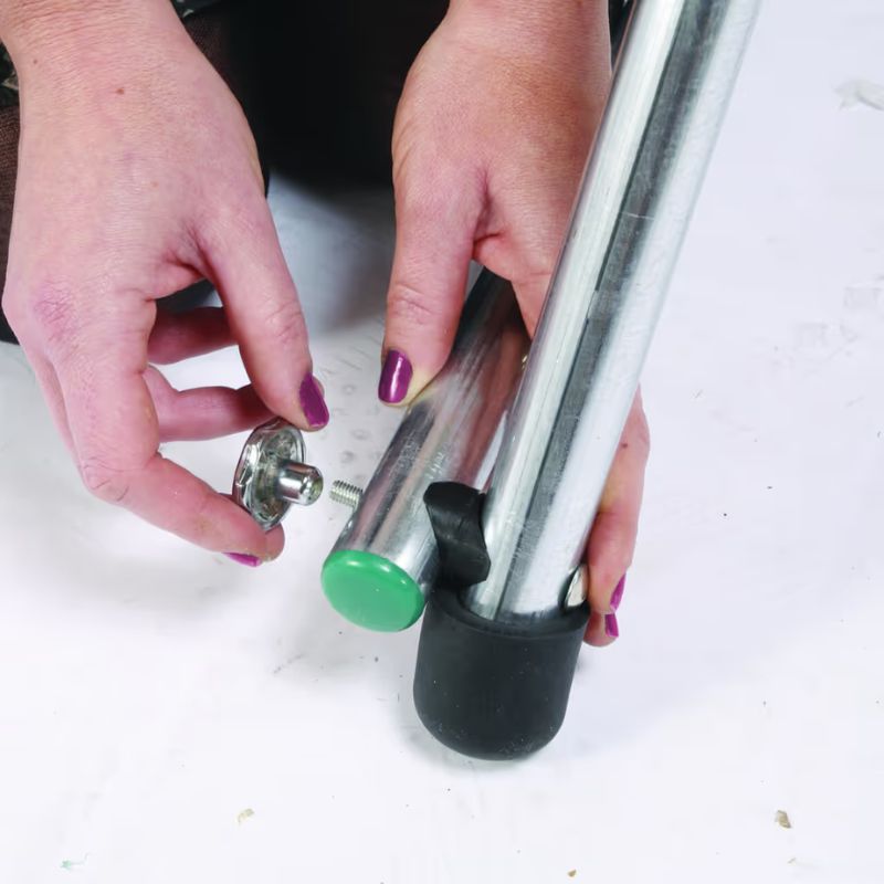 Close-up of the TFH Foldaway Swing Frame's leg assembly hardware, showing the simple click-together setup for this portable swing stand