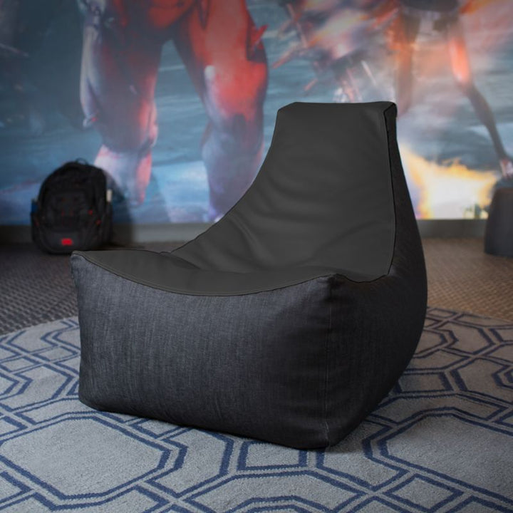 The Jaxx Pixel gaming bean bag chair in black sits in a game room, a durable seat for classrooms