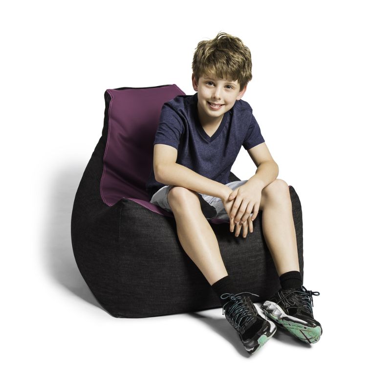 A boy sits comfortably in the Jaxx Pixel gaming bean bag chair in purple, a low seat for kids' reading corners