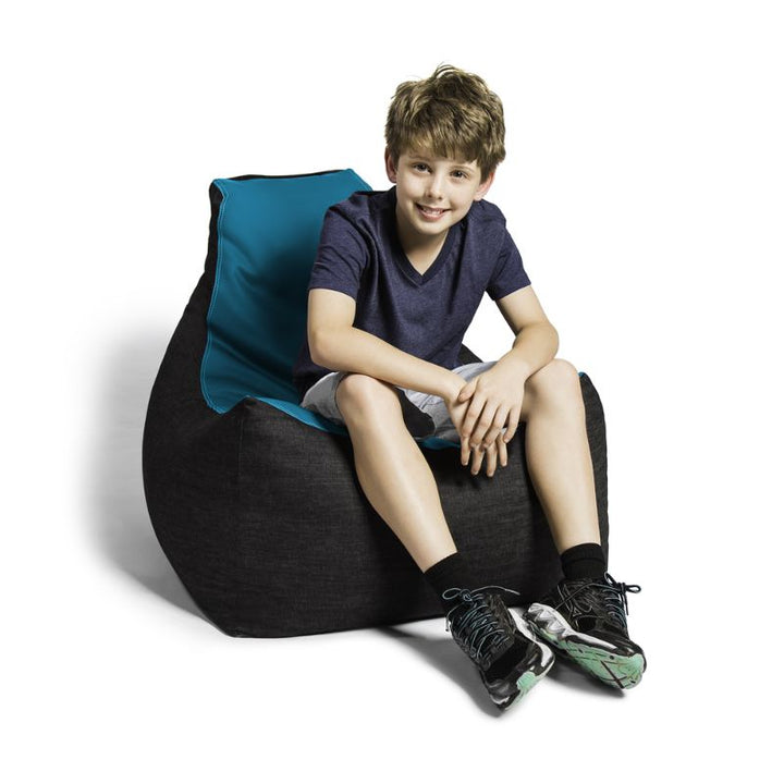 A boy sits comfortably in the Jaxx Pixel gaming bean bag chair in teal, a wipes-clean seat for classrooms