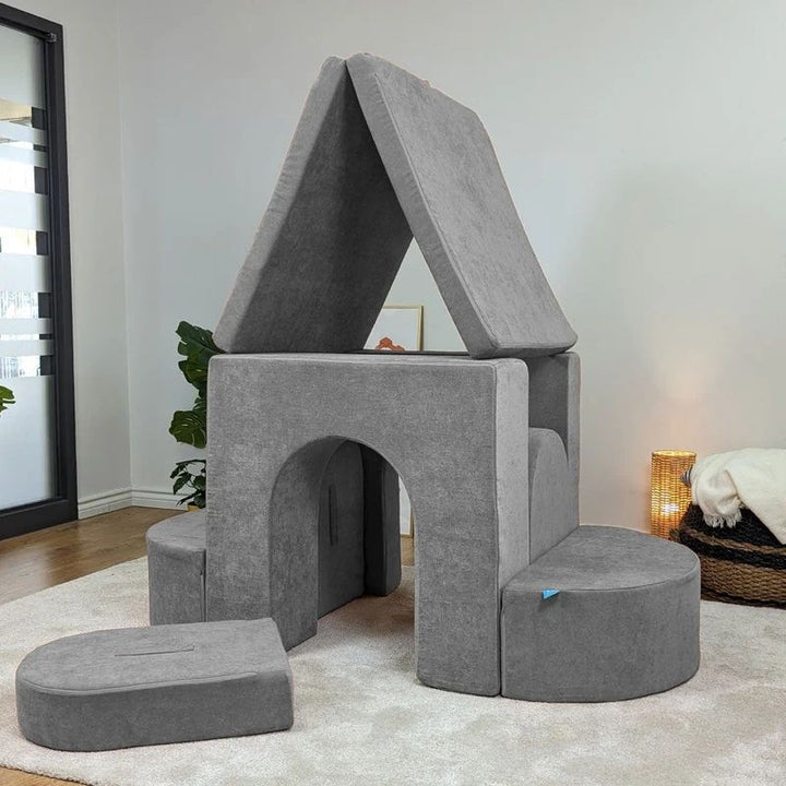 Go Coconut Architect Bundle configured as a house showing thick wall, thin wall, and door pieces creating a foam house structure with walls and doorways, demonstrating the architectural fort building possibilities of the 8-piece modular play couch