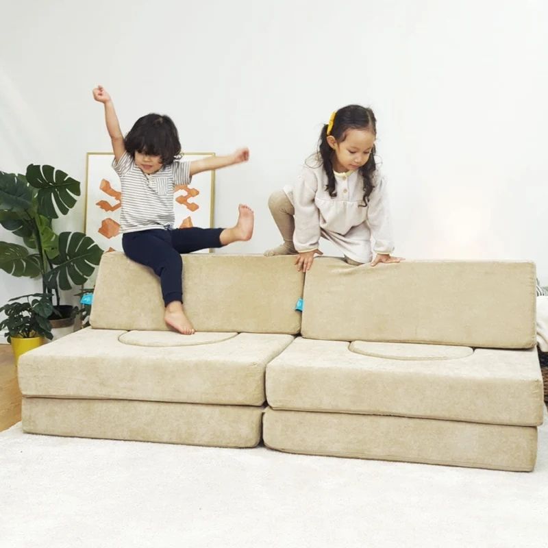 Two children in a third active play configuration with the Go Coconut Builder Bundle demonstrating the gross motor development, creative building, and enclosed sensory play value of the 7-piece Canadian-made modular foam play couch