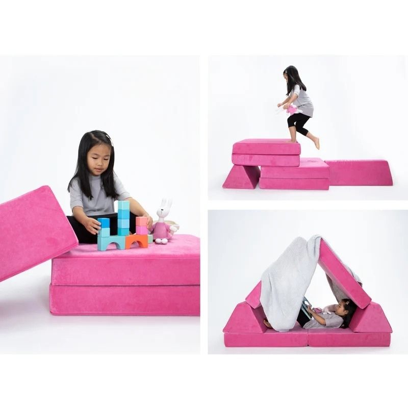 Child actively playing on Go Coconut - The Coconut in Pitaya Punch demonstrating the creative building and proprioceptive sensory play value of the modular Canadian-made CertiPUR foam play couch