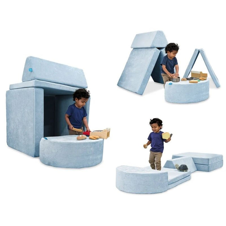 Child actively building and playing on Go Coconut - The Coconut in Polar Plush showing the open-ended Montessori-inspired foam configurations of the 100% Canadian-made modular play couch