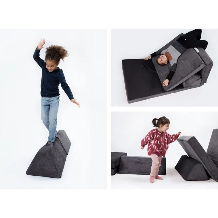 Children actively playing on Go Coconut - The Coconut in Charcoal Chill demonstrating the Montessori-inspired open-ended foam configuration possibilities of the Canadian-made play couch
