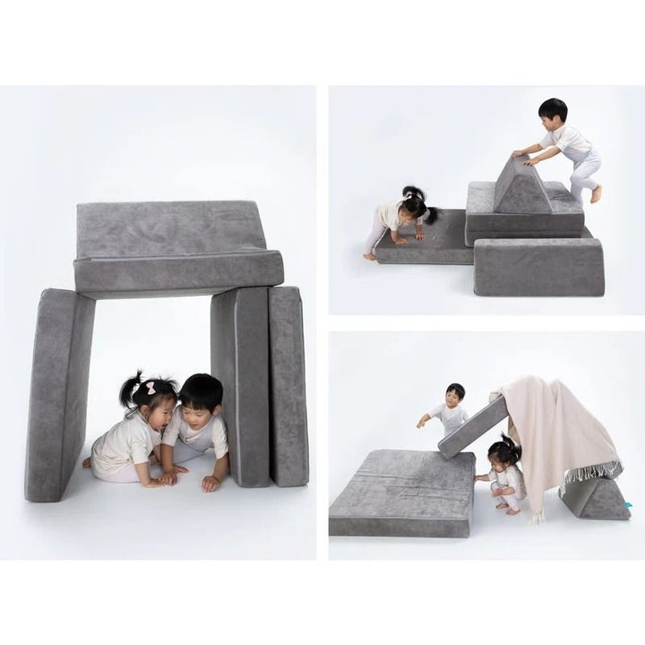 Children actively playing and building configurations on Go Coconut - The Coconut in Rhino Tango demonstrating the open-ended Montessori-inspired design of the Canadian-made modular play couch