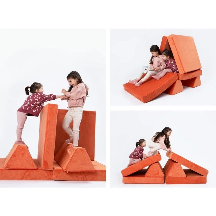 Children actively playing and building on Go Coconut - The Coconut in Twisty Tangerine demonstrating the modular foam configurations of the Montessori-inspired 100% Canadian-made play couch
