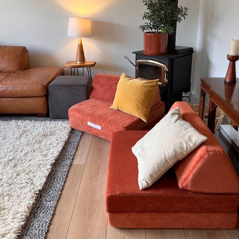 Go Coconut - The Coconut in Orange shown in an indoor home environment demonstrating how the modular 60x30x20in Canadian-made CertiPUR foam play couch integrates into living room and playroom spaces