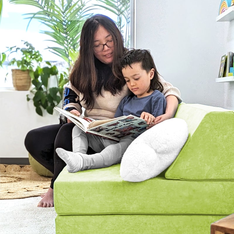 Mom and child using the Go Coconut Half Coconut in Lima Limon, side view showing active sensory and motor play at home