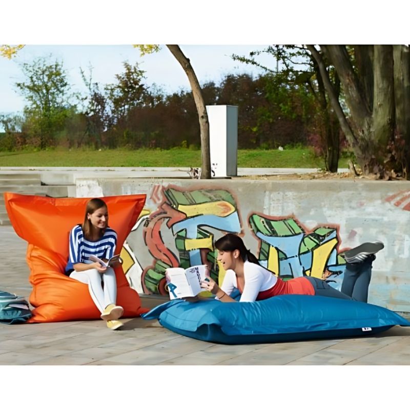 Adults relaxing outdoors on the HABA Pro Turquoise Bean Bag Cushion, showing its all-terrain sensory seating versatility for outdoor environments