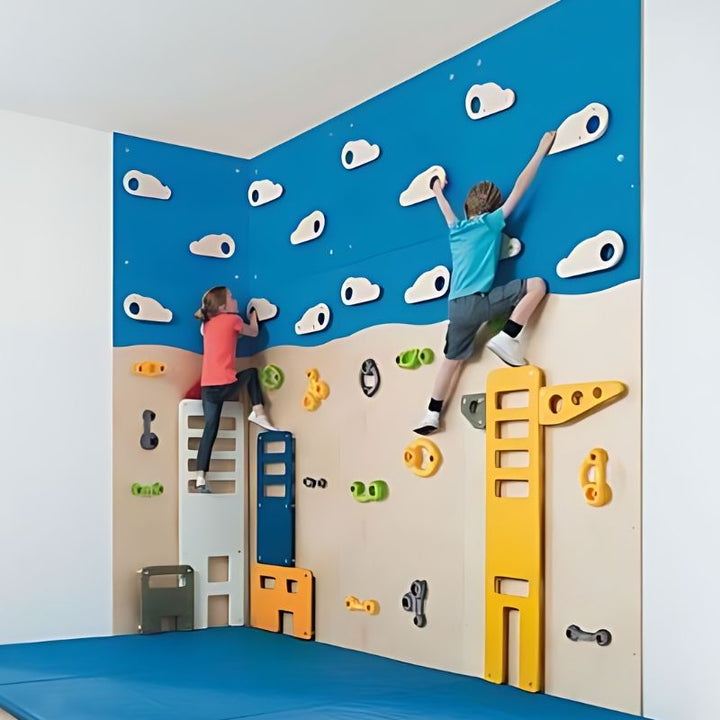 Two children climbing the HABA Pro Climbing World City Wall Panels in a corner installation, with blue safety mat below, showing how panels connect for schools and commercial spaces