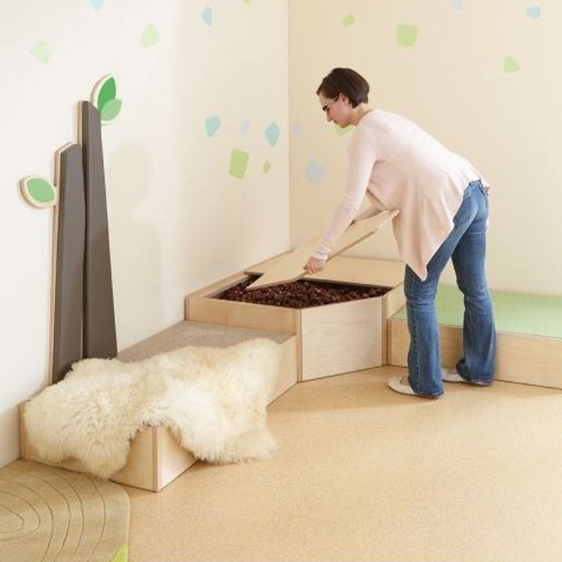 Adult installing the HABA Pro Grow.upp Corner Cave Cover onto the Sensory Bath Platform, showing setup process