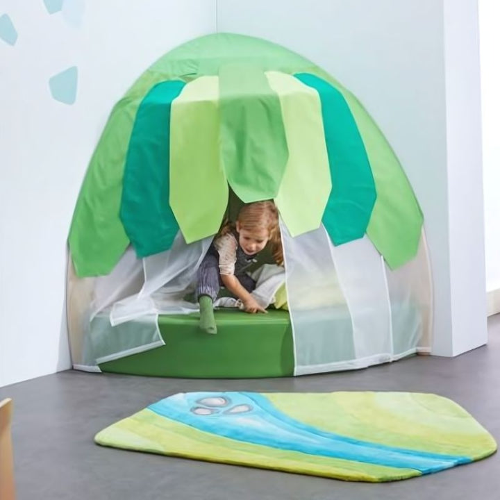 Girl playing independently inside the HABA Pro Grow.upp Canopy Retreat Cave, a sensory hideaway for classrooms and homes