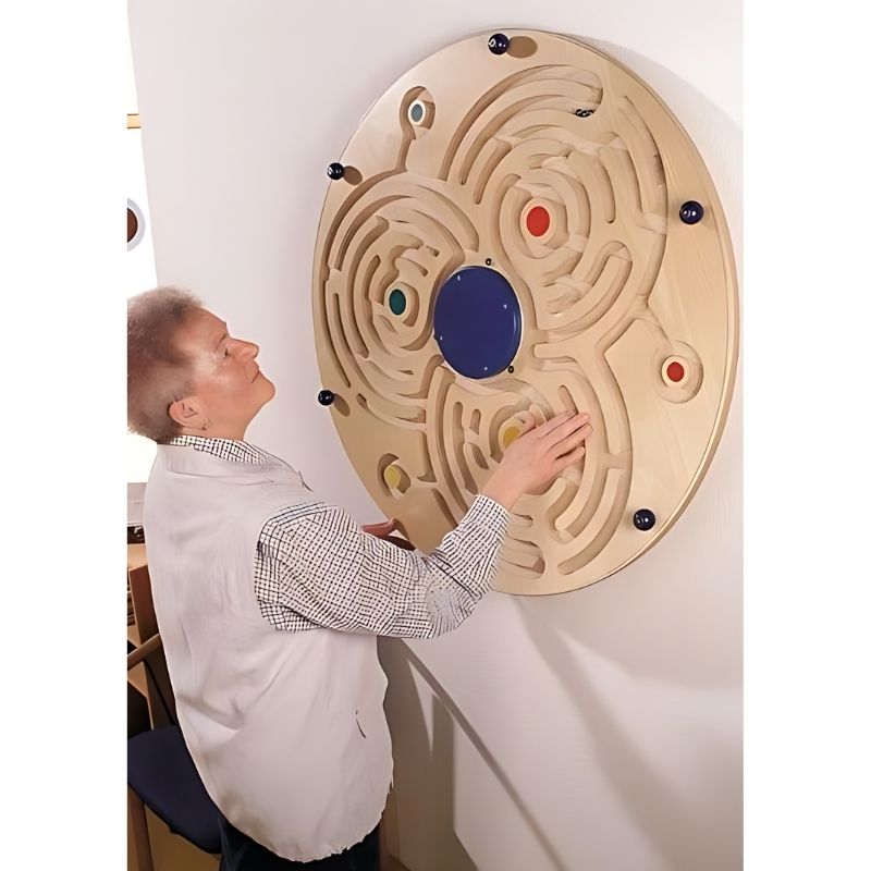 Detail view of the HABA Pro Large Ball Labyrinth sensory wall activity panel, birch plywood construction with clear acrylic glass panel and three steel balls