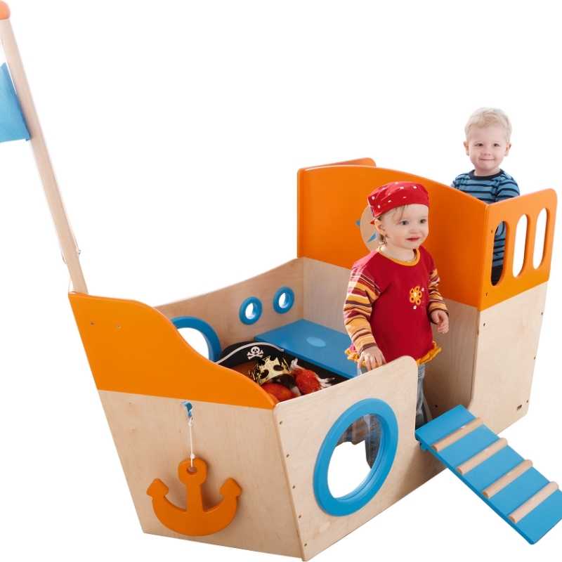 Two children playing aboard the HABA Play Sailboat, a commercial playhouse for classrooms and daycares
