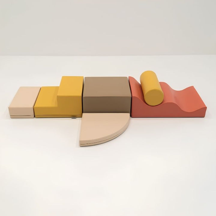 The six individual foam shapes of the IGLU Explorer Soft Play Set in a yellow and terracotta colourway, shown side by side