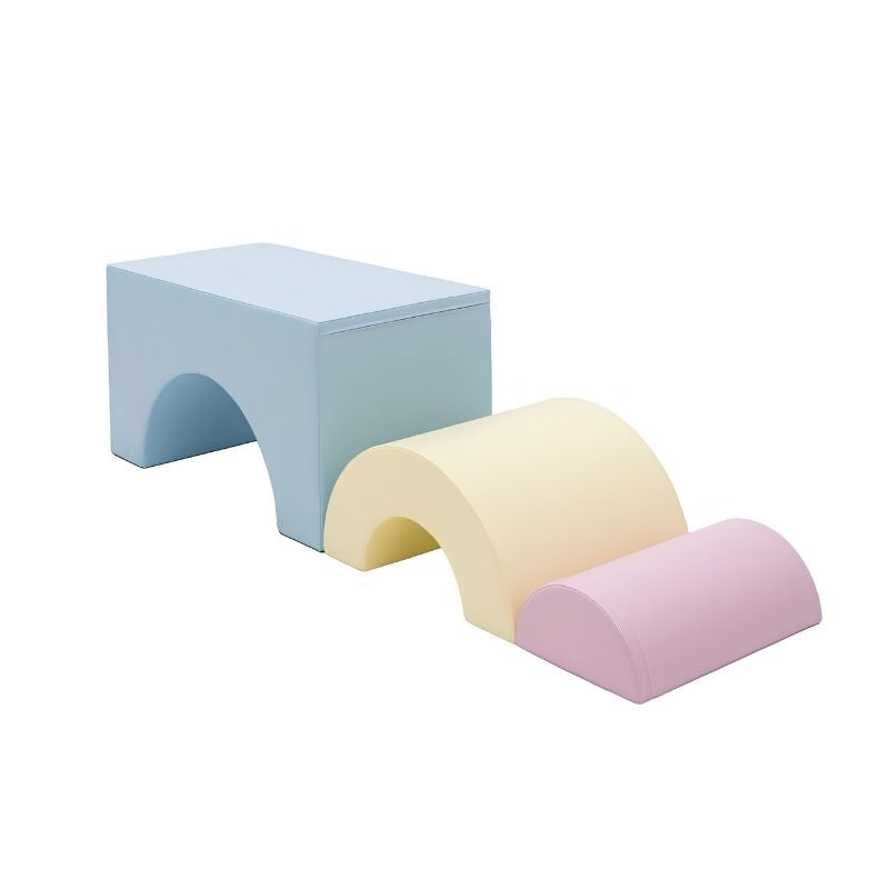 IGLU Rainbow Bridge Soft Play Set arranged as an obstacle course with the large blue bridge, medium cream arch, and small pink dome standing independently in a descending sequence for toddler climbing