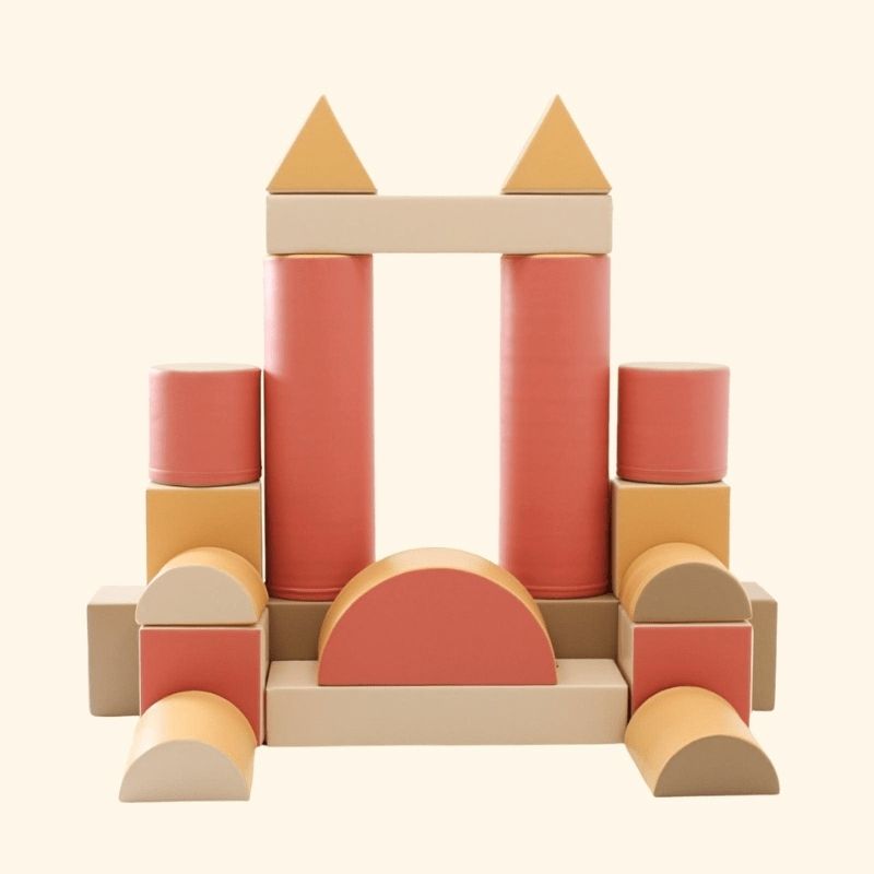 Clean product image of the IGLU Soft Play Fortress foam blocks in pastel pink, showing the eco-leather surface and overall set quality