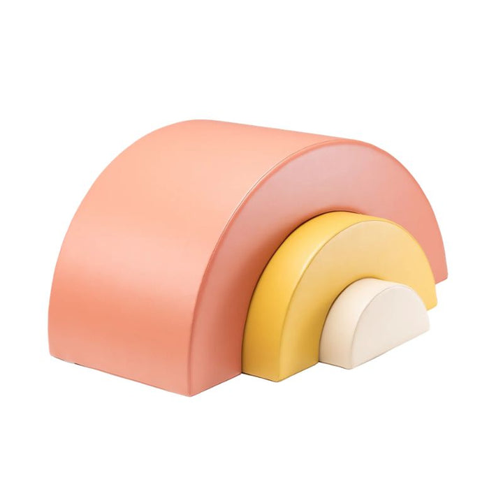 Coral, yellow and white rainbow arch piece from the IGLU Soft Play Gym, a foam shape for climbing and imaginative play