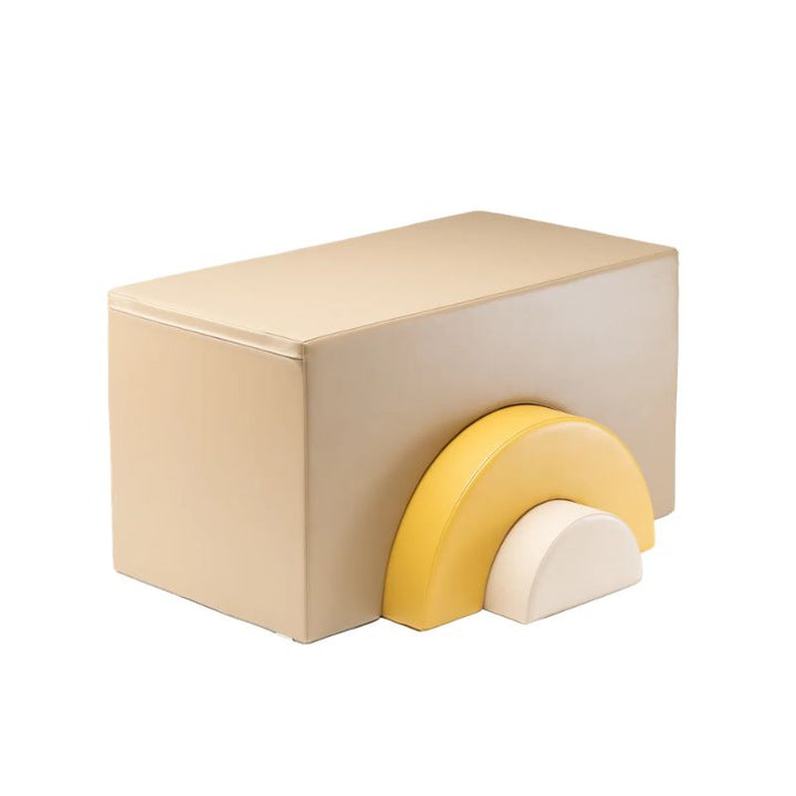 Tan foam block with a yellow and white rainbow arch from the IGLU Soft Play Gym, a piece for crawling through and climbing