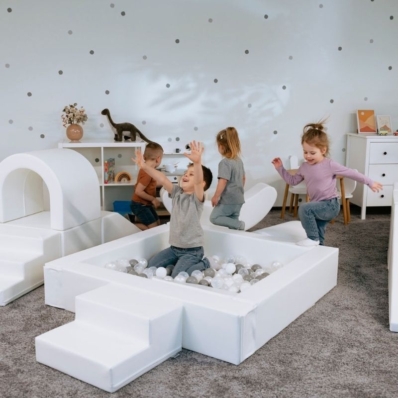 IGLU Soft Play Party Set with four children climbing, sliding and playing on the full 8-piece foam soft play set for ages 1 to 9