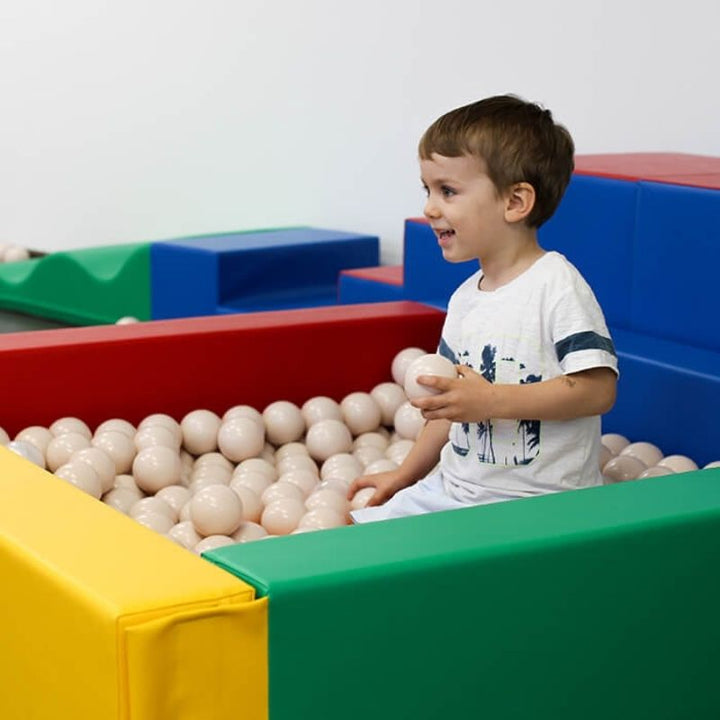 Child actively playing in IGLU Soft Play Square Ball Pit in multi-colour, demonstrating gross motor and vestibular sensory play