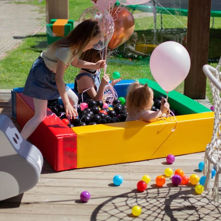 Three children playing together in IGLU Soft Play Square Ball Pit in multi-colour, supporting social skills and cooperative sensory play