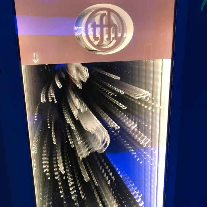 Close up of the TFH logo and rising bubbles at the top of the Infinity Bubble Wall, showing the multiply reflected bubble effect